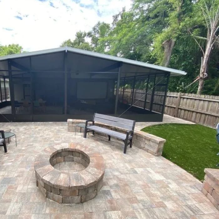 a backyard with firepit and chair